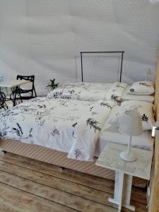 a bed with a black and white comforter and pillows at Yenokavan Glamping in Ijevan