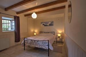 Schlafzimmer mit einem Bett und einem Fenster in der Unterkunft Gîtes du Chênelong Cantal in Marchastel