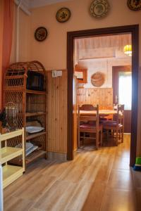 a room with a table and a dining room at Havellant Vendégház in Abádszalók +25 photos