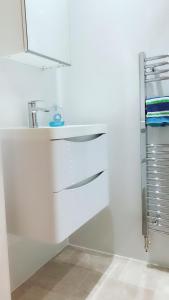 eine Küche mit weißen Schränken und einem Waschbecken in der Unterkunft Apartment Newington Area in Edinburgh