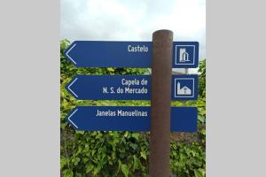 a pole with blue street signs on it at Villa Tauria- Casa de campo em aldeia medieval in Sabugal