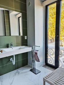 a bathroom with a sink and a mirror at Villa Tauria- Casa de campo em aldeia medieval in Sabugal