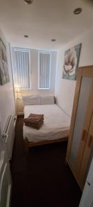 a small bedroom with a bed and a window at No 7 - 1 BED NEAR SEFTON PARK AND LARK LANE in Liverpool