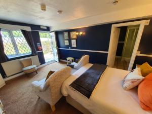 a hotel room with two beds and a television at The Snooty Fox in Looe