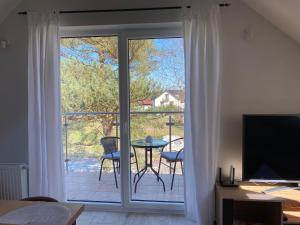 a room with a sliding glass door with a view of a patio at Apartament w Dębkach in Dębki