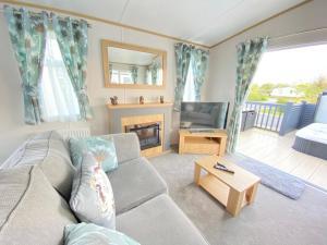 a living room with a couch and a fireplace at Squirrels Nest - Hot Tub - Pet Friendly in South Cerney