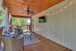 a screened porch with chairs and a ceiling fan at Captain Puddle Pirate's Hideaway - Near All Sevierville & Pigeon Forge Attractions & Great Smoky Mountains NP home in Sevierville