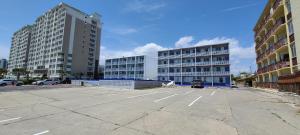 an empty parking lot with two tall buildings at Oceanfront Twilight Surf Hotel in Myrtle Beach