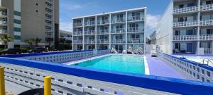 a swimming pool in front of a building at Oceanfront Twilight Surf Hotel in Myrtle Beach