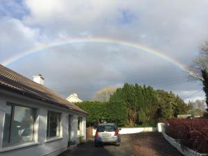 a rainbow in the sky over a house at Carrick-on-Shannon Guest House in Carrick on Shannon