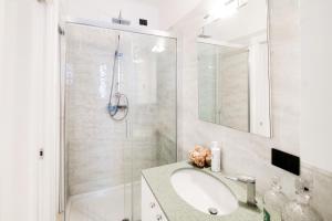 a bathroom with a sink and a shower at Promenade - My Home In Como in Cernobbio +17 photos
