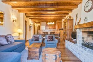 a living room with a couch and a fireplace at Baqueira Apartamentos Cota 1700 a pie de pistas in Baqueira-Beret