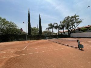 a tennis court with a net on top of it at La Reserva Chapala in Ajijic