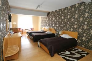 Postel nebo postele na pokoji v ubytování Hotel Gregor