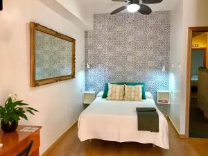 a bedroom with a bed and a blue and white wall at Guadalupe Cozy Inns in Torremolinos