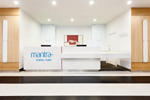 a store with a white counter with a sign on it at Mantra Charles Hotel in Launceston