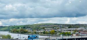 a view of a town with a river and a city at Login house B in Derry Londonderry