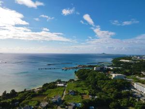 an aerial view of the ocean and a city at Irie House Motobu in Motobu