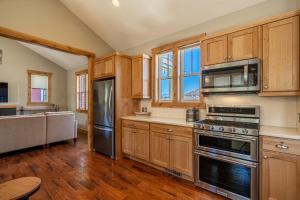 a kitchen with wooden cabinets and stainless steel appliances at Northern Lights #71 in Chelan