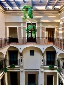 a large building with a balcony and plants on it at Hotel Gala in Puebla