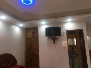 a room with a flat screen tv on a wall at HOSTAL SAN FRANCISCO in San Cristóbal