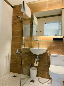 a bathroom with a shower and a sink and a toilet at King Wow Inn in Tainan