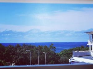 a view of the ocean from a building with street lights at Salt - 2brm apartment with Spa bath and Ocean Views in Kingscliff