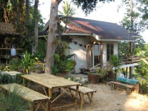 a small house with a picnic table in front of it at Lanlay Home Stay Krabi in Ao Luk