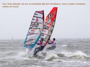 dos personas haciendo windsurf en el océano en el agua en B&B Elbahof, goed en goedkoop!, en Hem