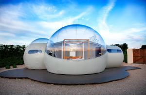 a building with a glass dome on the ground at Miluna in Hormigos