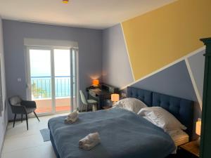a bedroom with a bed and a desk and a window at Hotel Elu Iris in Split