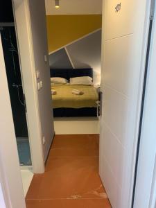 a small bedroom with a bed in the middle of a room at Hotel Elu Iris in Split