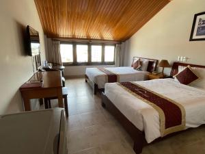 Postel nebo postele na pokoji v ubytování Sunshine Hoian Hotel