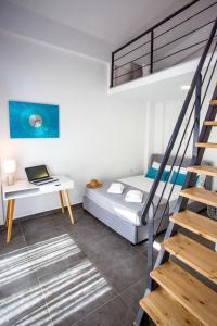 a bedroom with a bed and a desk with a laptop at JOY C Deluxe in Iraklitsa +25 photos