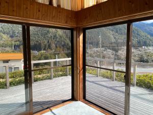 a view from the living room of a house with windows at 花緑里-Hanamidori-そしの山荘 岐阜下呂金山郡上貸切ロッジ高原リゾート in Gujo