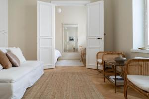 a living room with a white couch and a table at Roost Roobert 3 in Helsinki