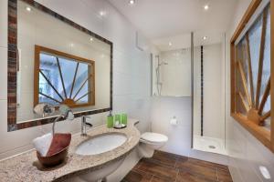 a bathroom with a sink and a toilet and a mirror at Ferien im Steinberg in Ramsau +38 photos