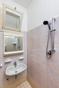 a bathroom with a sink and a mirror at Albergo Gloria in Bellaria-Igea Marina