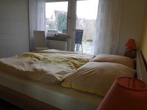 a bedroom with two beds and a window at Appartment Schlossblick in Wiesenthau
