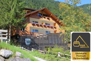 a building with a sign in front of it at Alpen Suites Brandnertal in Brand