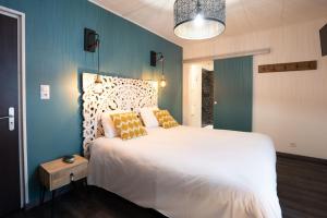 Llit o llits en una habitació de Logis Central Hôtel - Restaurant & Spa