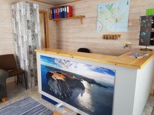 a desk in a room with a picture of the ocean at Hytte Camp Nordkapp - Blue in Skarsvåg