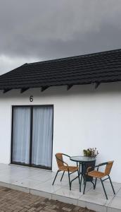 a patio with two chairs and a table in front of a building at Casa Mo Boutique Guest House in Bloemfontein