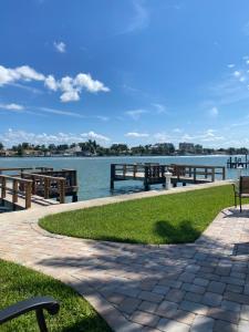 a walkway next to the water with a dock at Treasure Island Beach, FL Waterfront Condo in St Pete Beach
