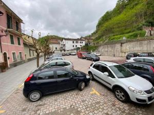 a group of cars parked in a parking lot at HH Hermoso Housing SERRAVALLE in Serravalle Scrivia