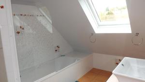 a white bathroom with a shower and a sink at A L Ancre de la Rive in Le Faou