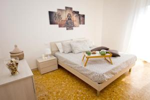 a bedroom with a bed with a table on it at Apt luminoso, spazioso con Aria condiz e bici in Viareggio