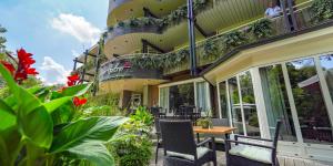 a balcony of a building with a table and chairs at Hotel Hof van Gelre by Flow in Lochem