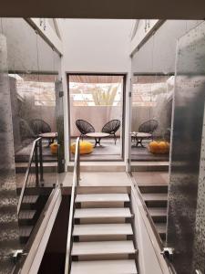 a staircase leading to a room with a table and chairs at Villa Zawaia B&B in Lagos