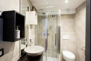 a bathroom with a shower and a toilet and a sink at Apartments Villa Sofia in Crveni Vrh +47 photos